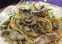 Pork, mushrooms and fettuccine in garlic wine sauce
