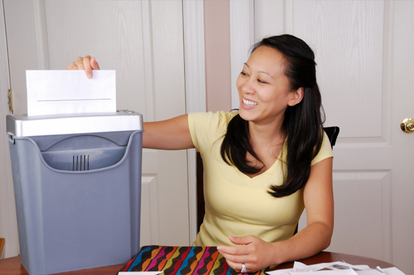 Woman shredding paper