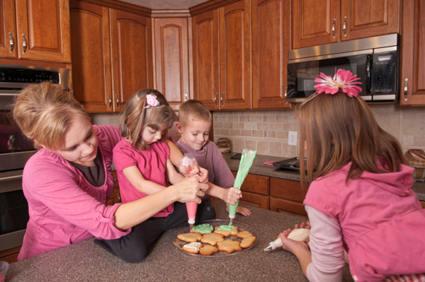 Mom and kids baking cookies