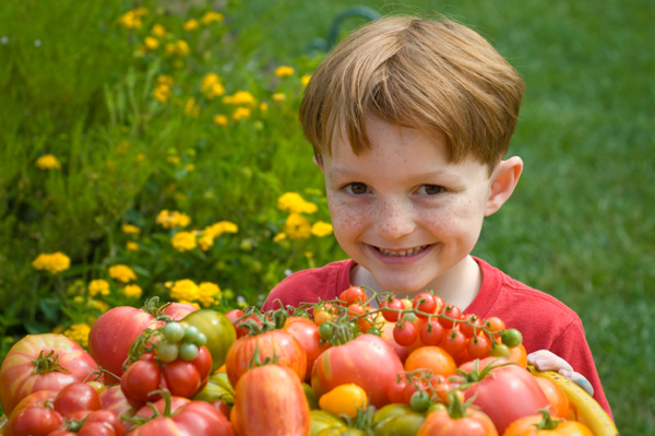 Boy with vegetables from garden