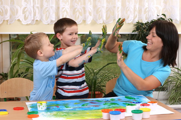Mom fingerpainting with kids