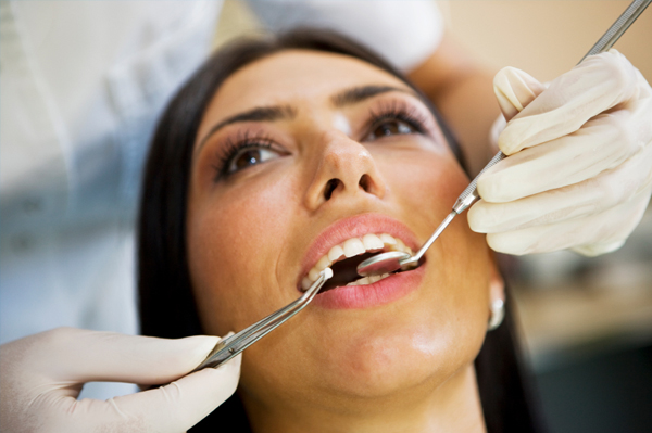 Woman at dentist getting enamel checked