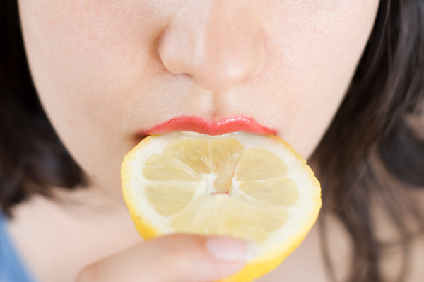 Woman Eating Lemon