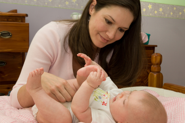 Mother diapering child