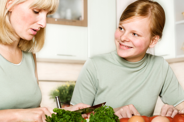 Mom and teen cooking