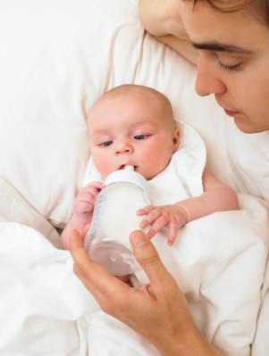 Burping A Baby. dad feeding young aby a