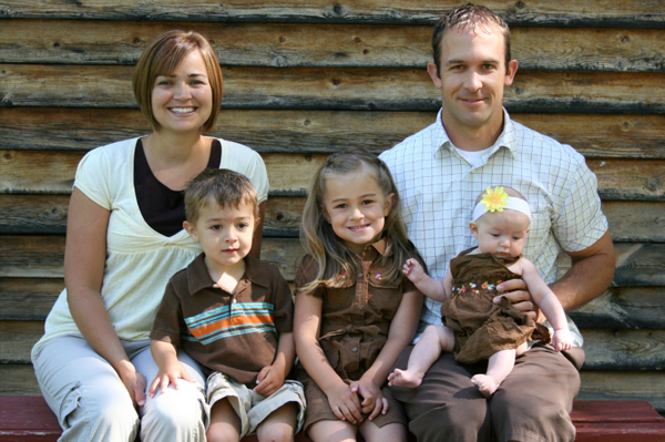 Family outside cabin
