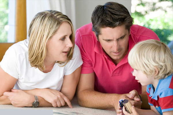 Mom and dad talking about finances with son
