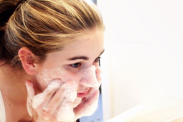Teen girl washing face