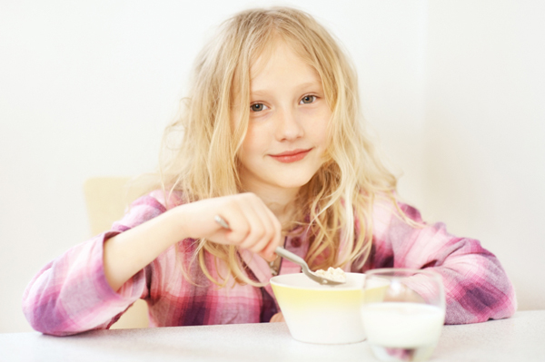 Little girl eating oatmeal Mornings are rushed enough without adding a