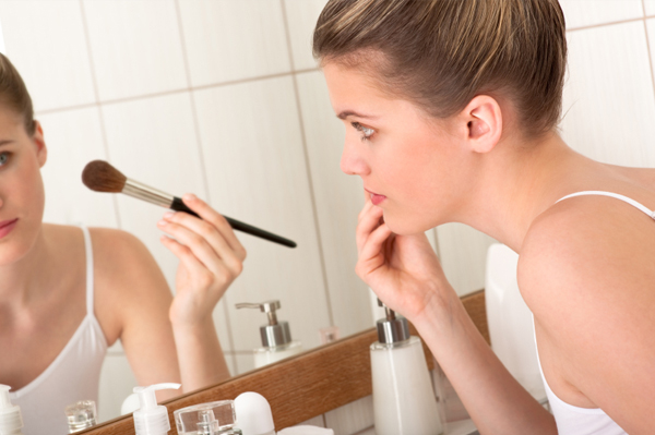 Woman applying makeup