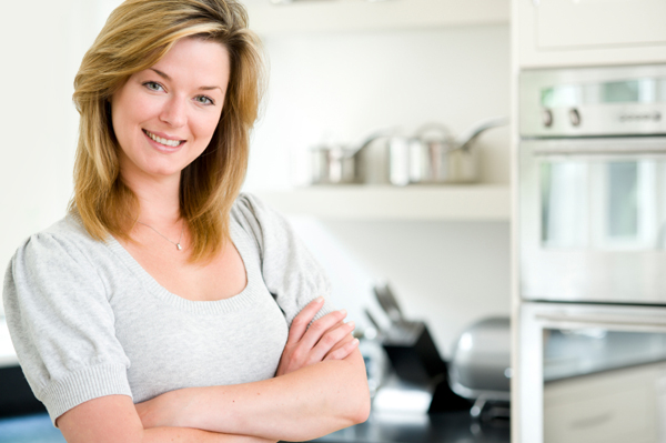 Woman in clean, organized kitchen