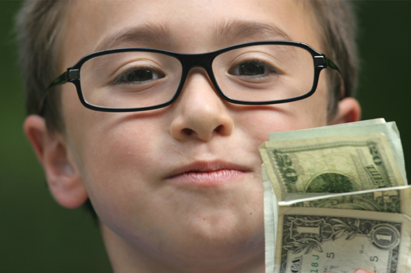 Boy holding his allowance
