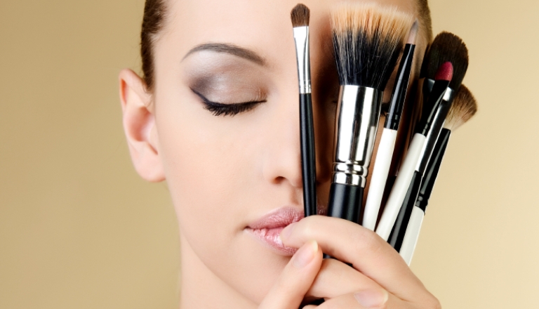 woman holding makeup brushes