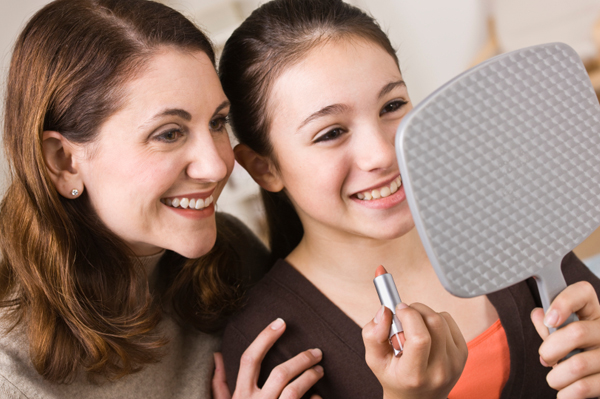 Mom and daughter applying makeup