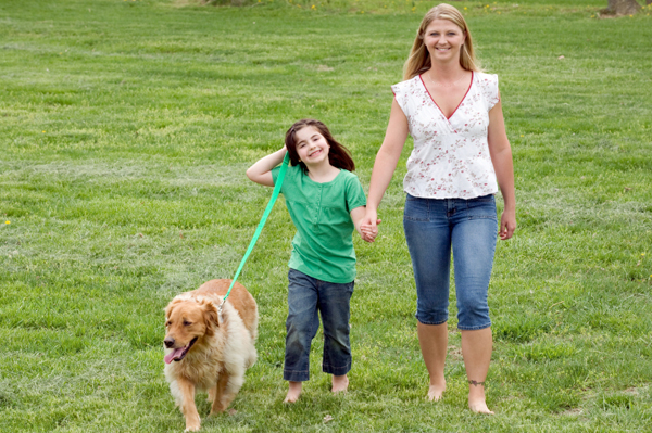 Mom walking dog with daughter