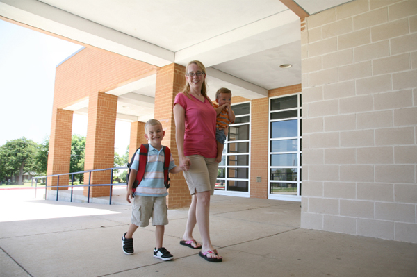 Mom walking son to school