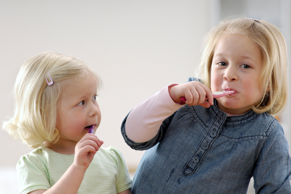 Sisters brushing teeth