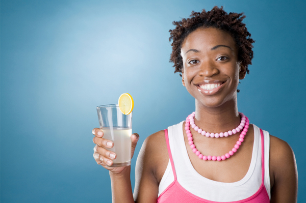 Woman drinking water with lemon