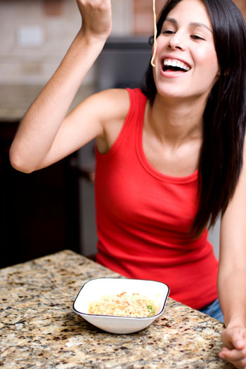 Woman eating pasta