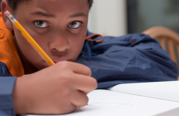 boy writing in class