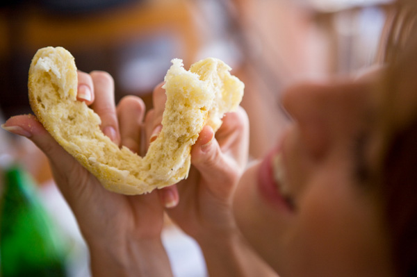 Happy woman eating bread