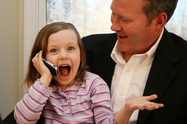 Little girl talking on phone to mom