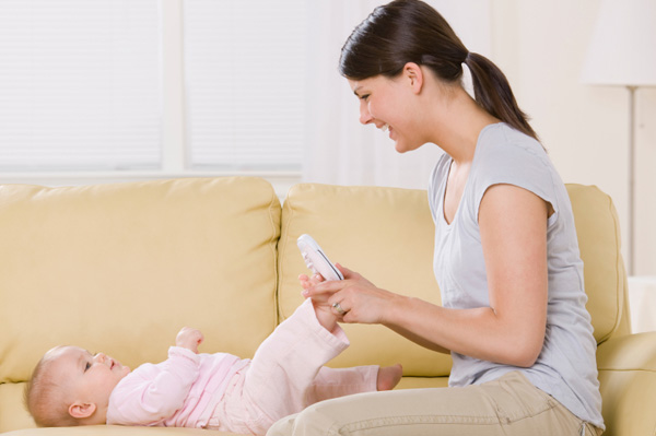 Mom dressing baby