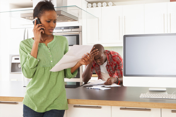 Woman on phone looking at bill