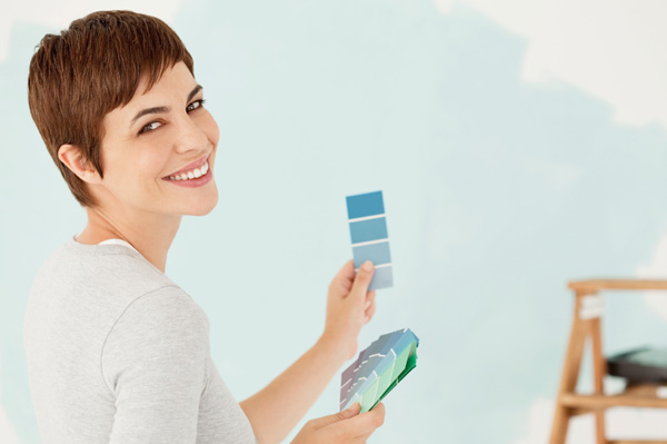 Woman painting bedroom