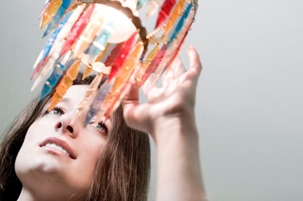 Woman touching chandelier