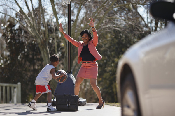 Woman playing basketball with son