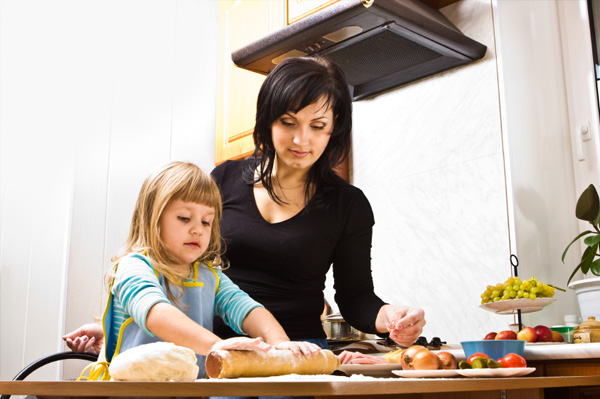 Mom and daughter making homemade pizza