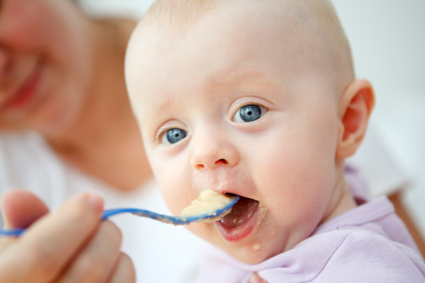 Mum feeding baby organic baby food