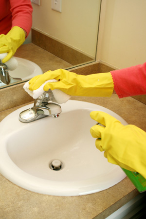 Woman cleaning faucet