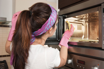 Woman cleaning microwave