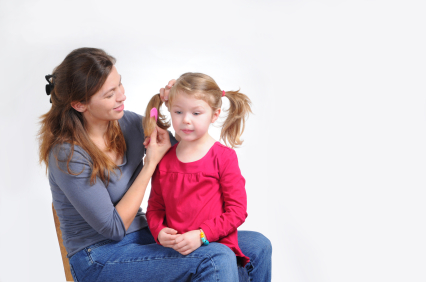 Mom brushing daughter's hair
