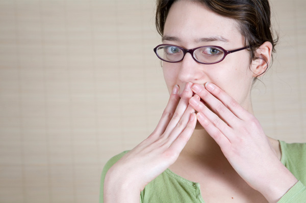 Woman covering mouth