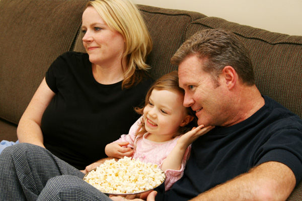 Family watching movie at home