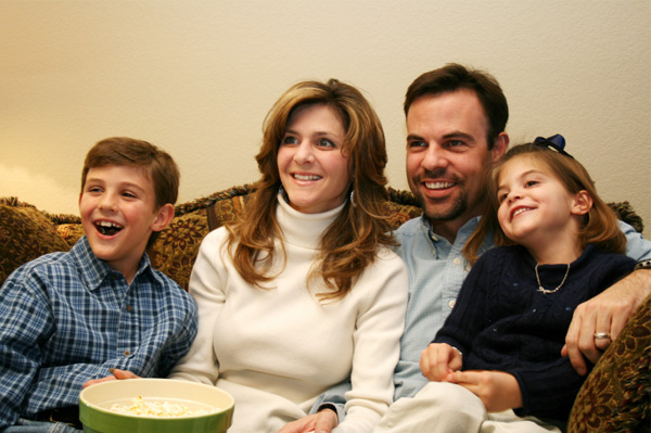 Family watching movie at home