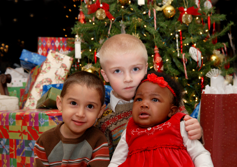 Baby by tree - Adopting at Christmas