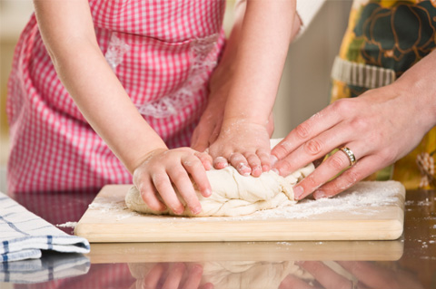 Mom daughter making bread