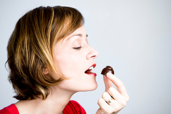 Woman eating dark chocolate