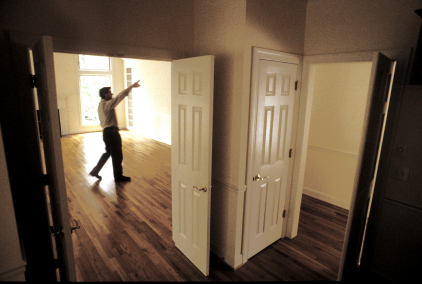 Real Estate Agent Shows a House