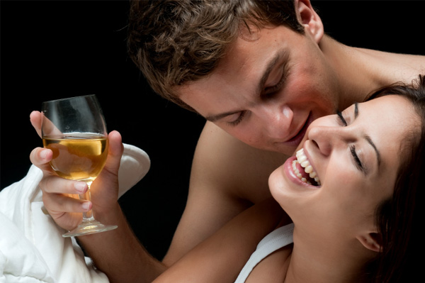 Couple in bed with wine