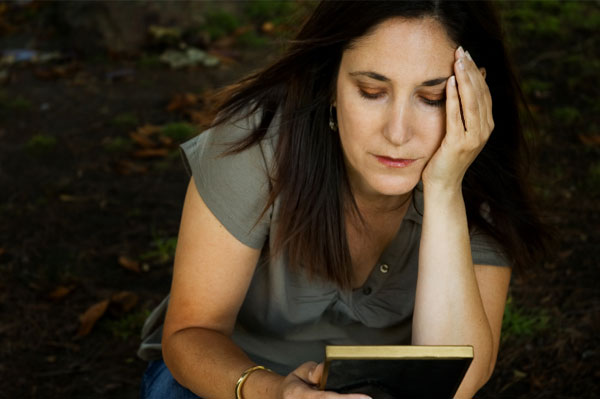 Sad woman holding a photo.