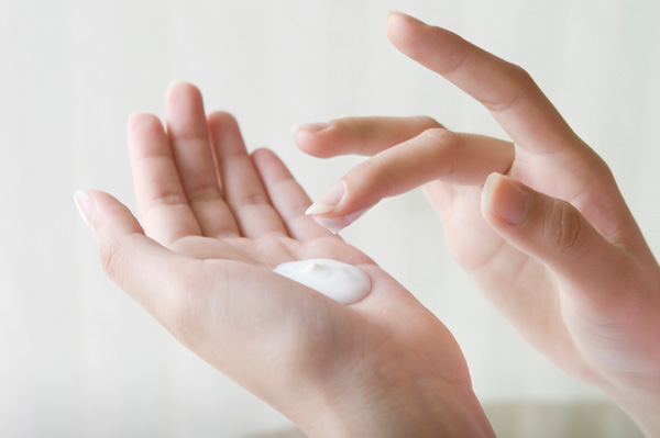 Woman applying hand cream