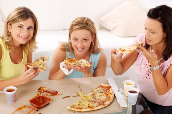 Woman eating delivery pizza