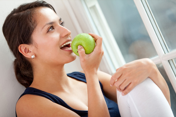 Woman snacking on apple