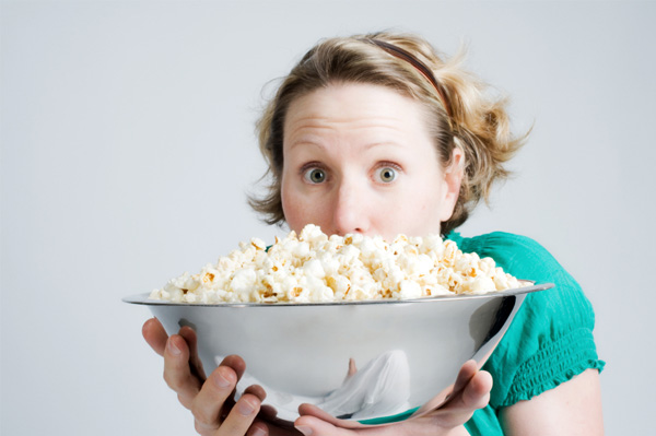 Woman with popcorn bowl